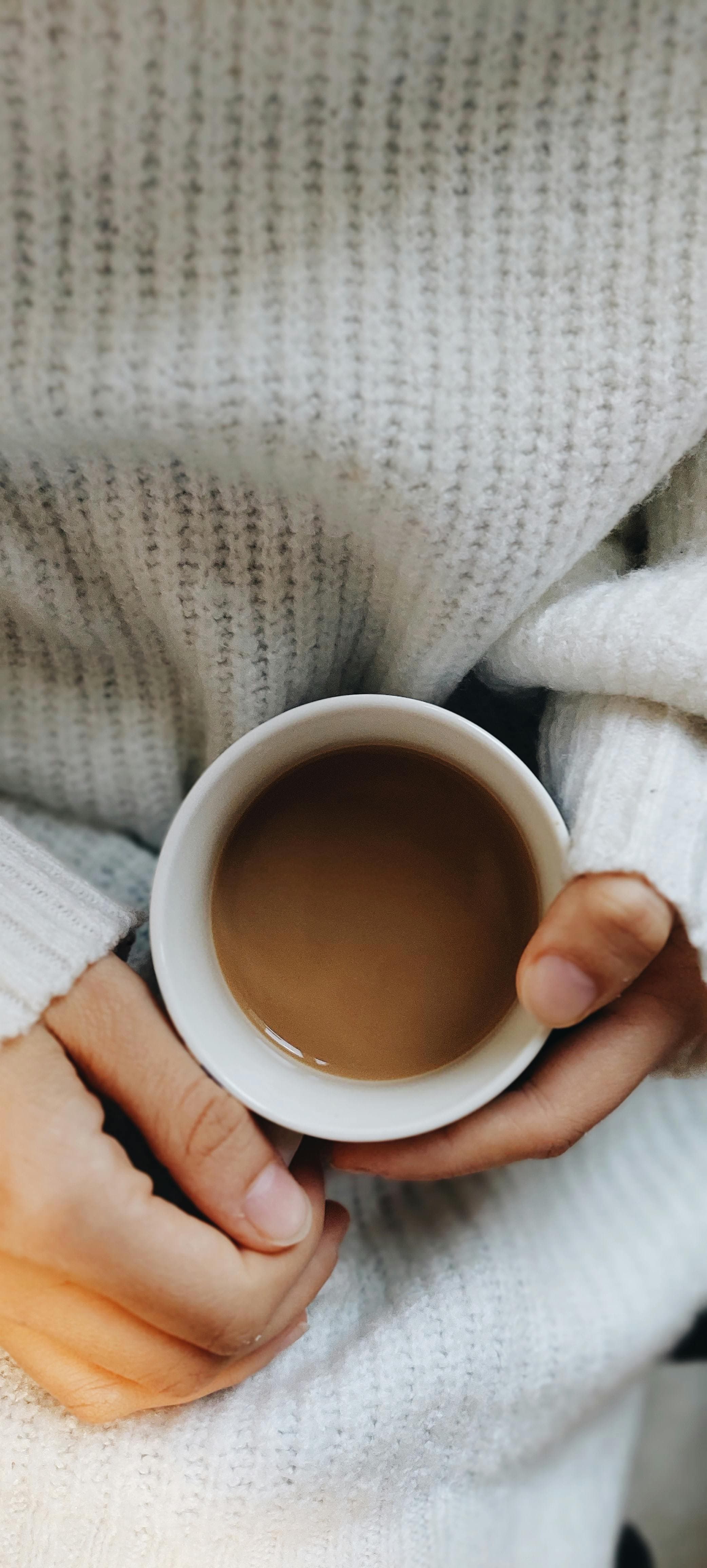 Hands holding a coffee cup