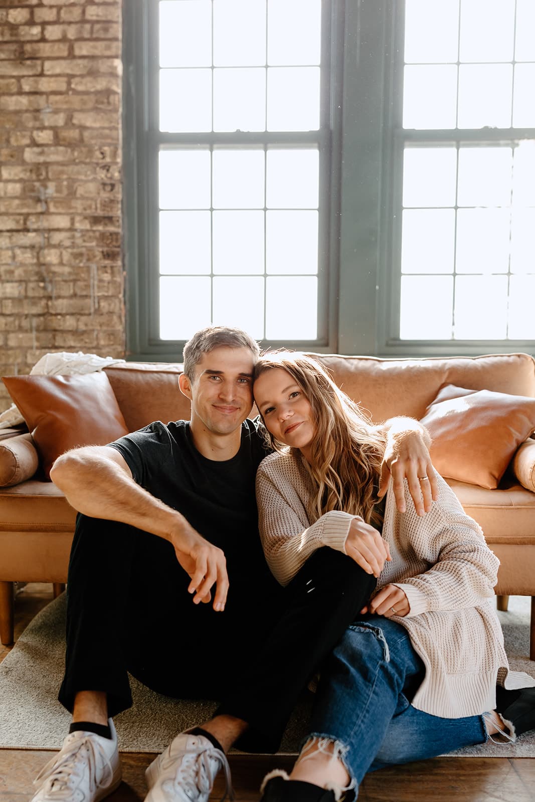 Xan and Nathaniel Sibley sitting together in a sunlit loft